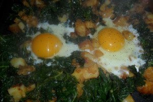 sunny side up eggs in kale and potatoes