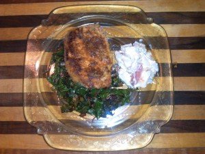 breaded pork chop on bed of swiss chard