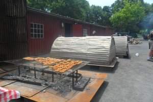 soft pretzels on trays over coals