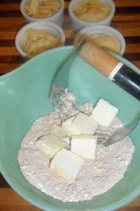 Mixing batter with ramekins ready in background.