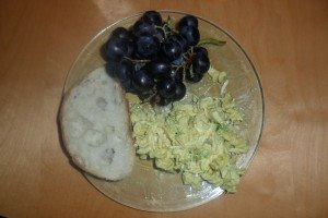 Chicken salad on plate with grapes and bread