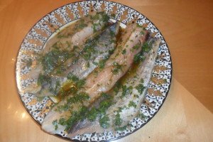 fish filets soaking in herb marinade