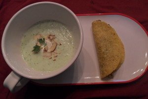 Cucumber soup with dollop of sour cream, sliced almonds and parsley