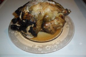 Finished whole, grilled chicken on plate