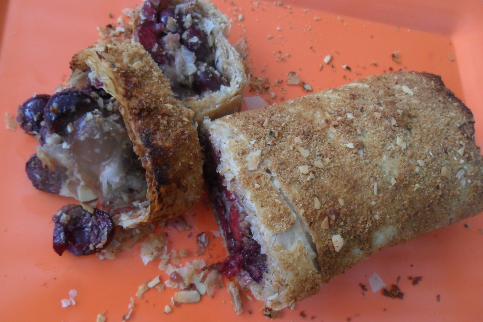 Baked, sliced cherry streudel on platter