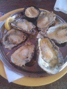 Half dozen baked oysters on plate