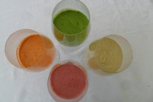 green, orange, purple, and yellow juice and smoothie drinks