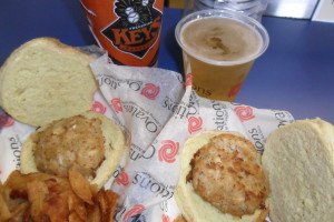 Two crab cakes, a beer, and a Frederick Keys cup.