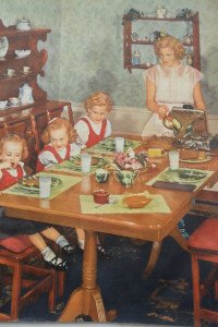 Mom in white gown making waffles for daughters