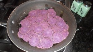 Sliced purple potatoes in pan