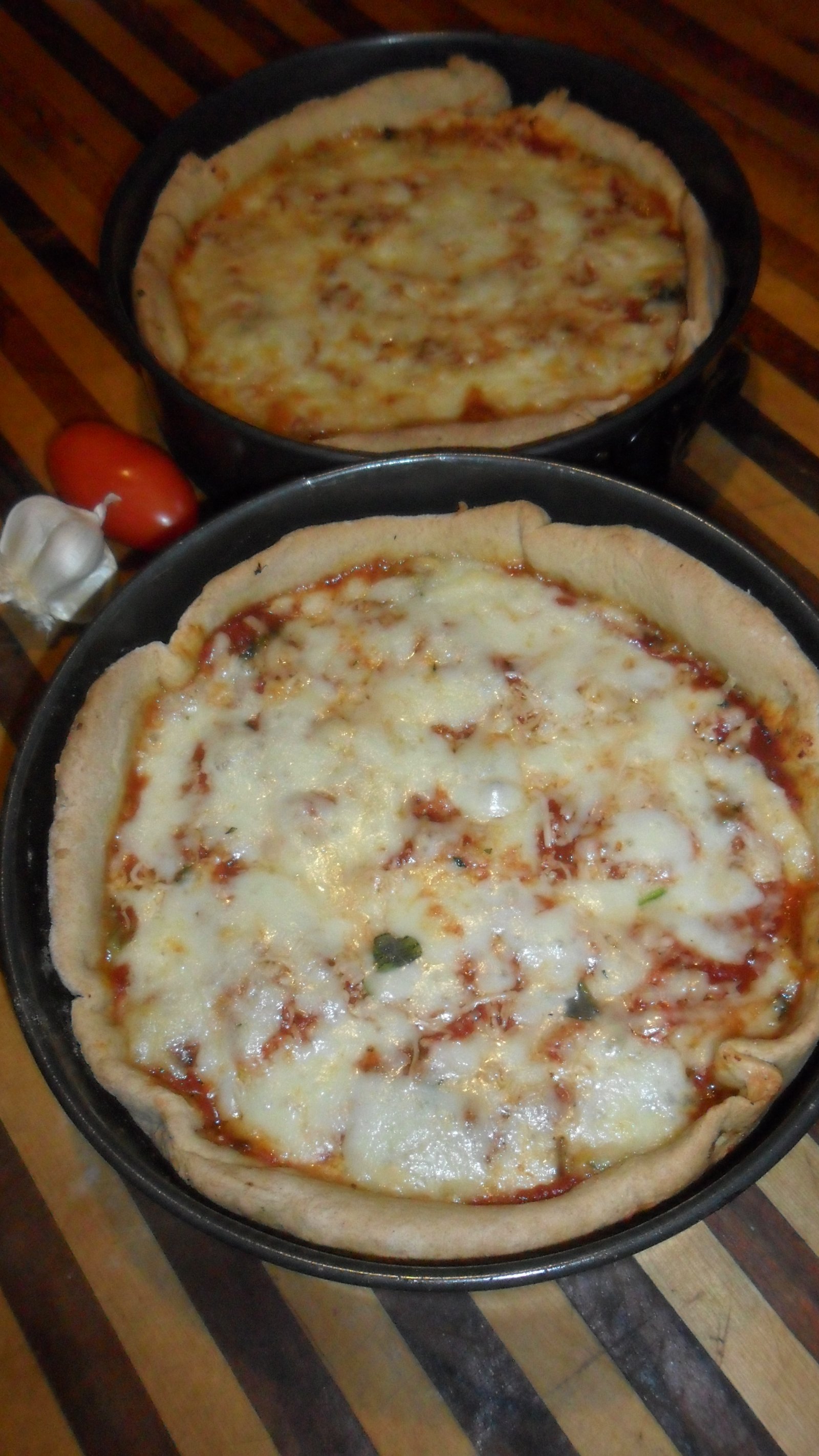 Two baked deep dish pizzas