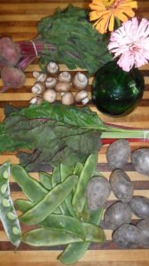 Variety of vegetables displayed on counter with daisies