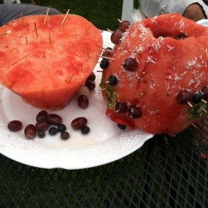 Two halves of watermelon with toothpicks in between