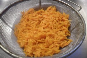 Shredded carrot in strainer