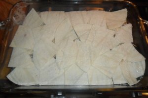 Spreading the tortilla quarters in the baking dish