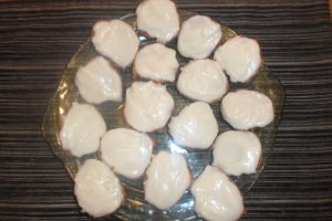 A platter full of frosted carrot cake cookies