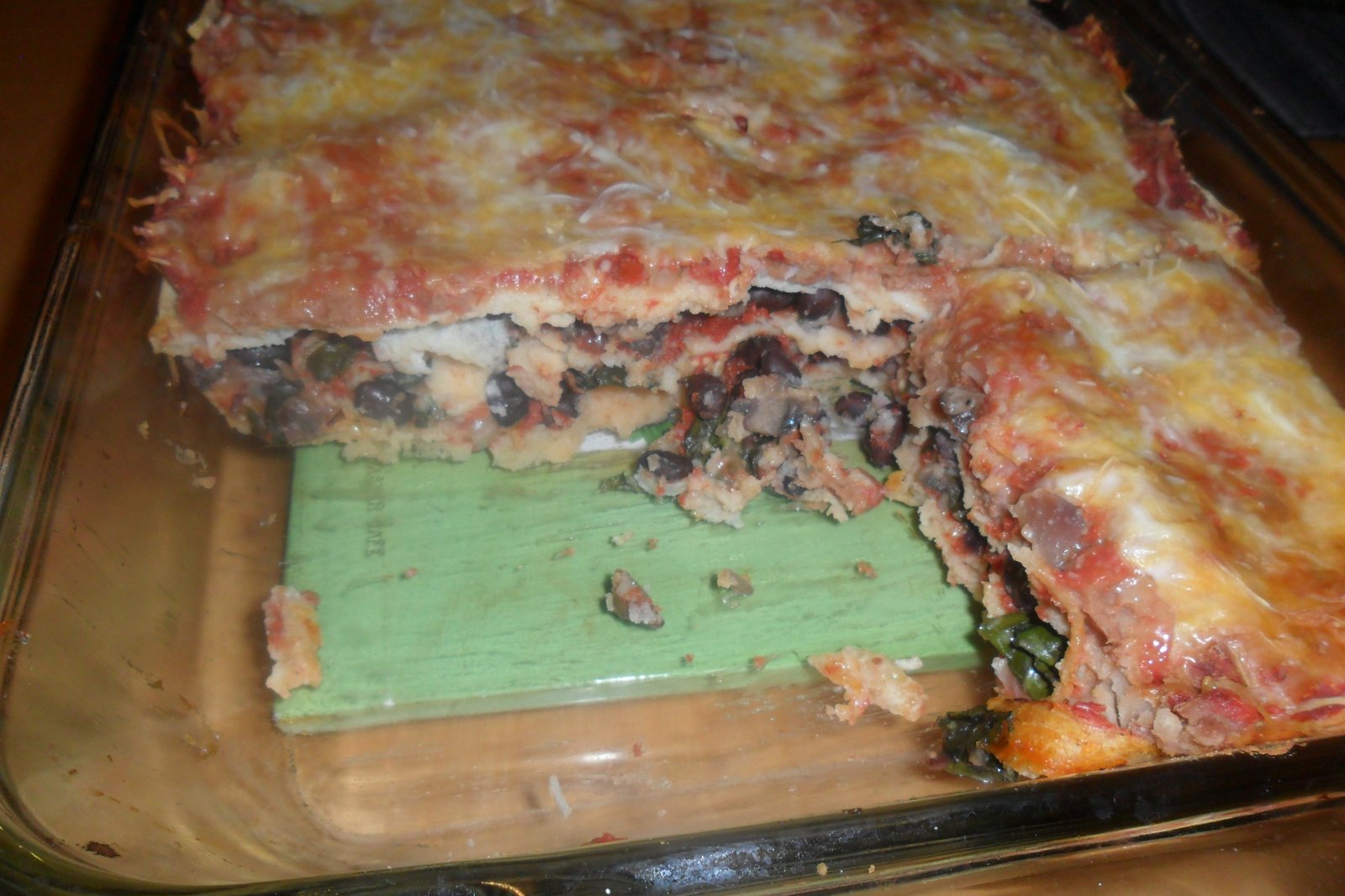 Baked swiss chard tortilla casserole with piece missing