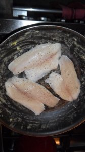 Fish cooking in pan.