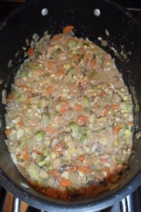 Dutch oven with cooked vegetables.