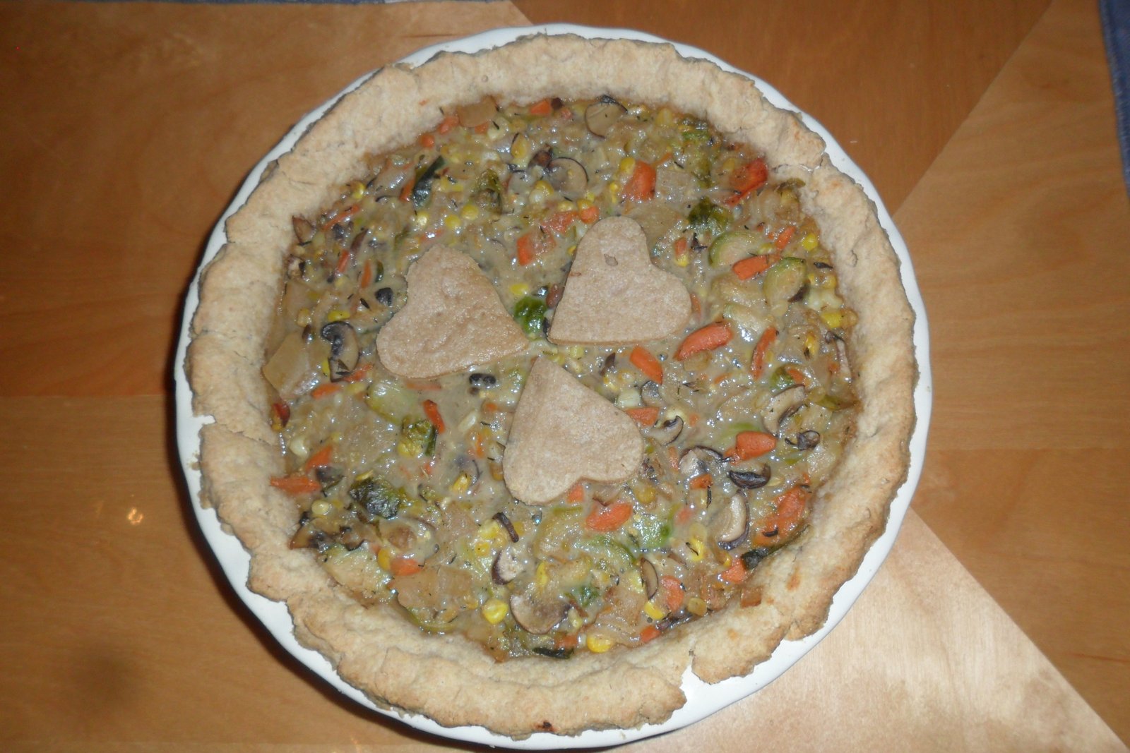 Baked vegetable pot pie decorated with crust hearts