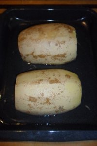 Spaghetti squash in pan ready for oven.