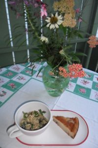 Serving plate of quinoia and broccoli raab with garden bouquet