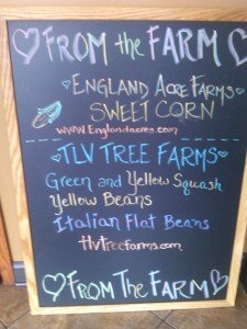 Chalkboard sign with list of local farm suppliers.