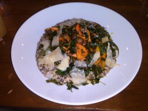 Risotto with colorful vegetables and shaved cheese topping.