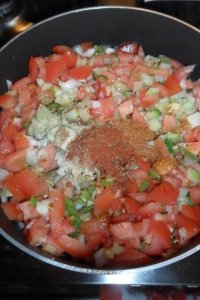 Lots of colorful spices going in the pan