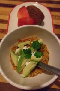 Serving jambalaya and avacado garnish with fruit.