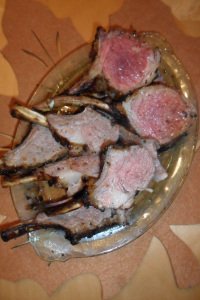 Serving tray with lamb chops on leaf placemat.