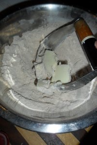 Cutting the butter into the flour with a pastry cutter