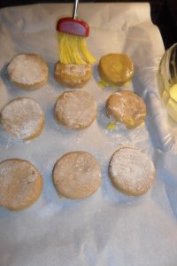 Brushing egg wash on cut biscuits