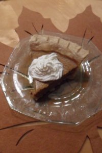 Serving of pie with whipped cream.