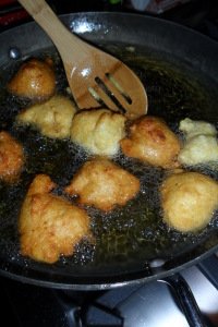 Turning the browning hushpuppies.