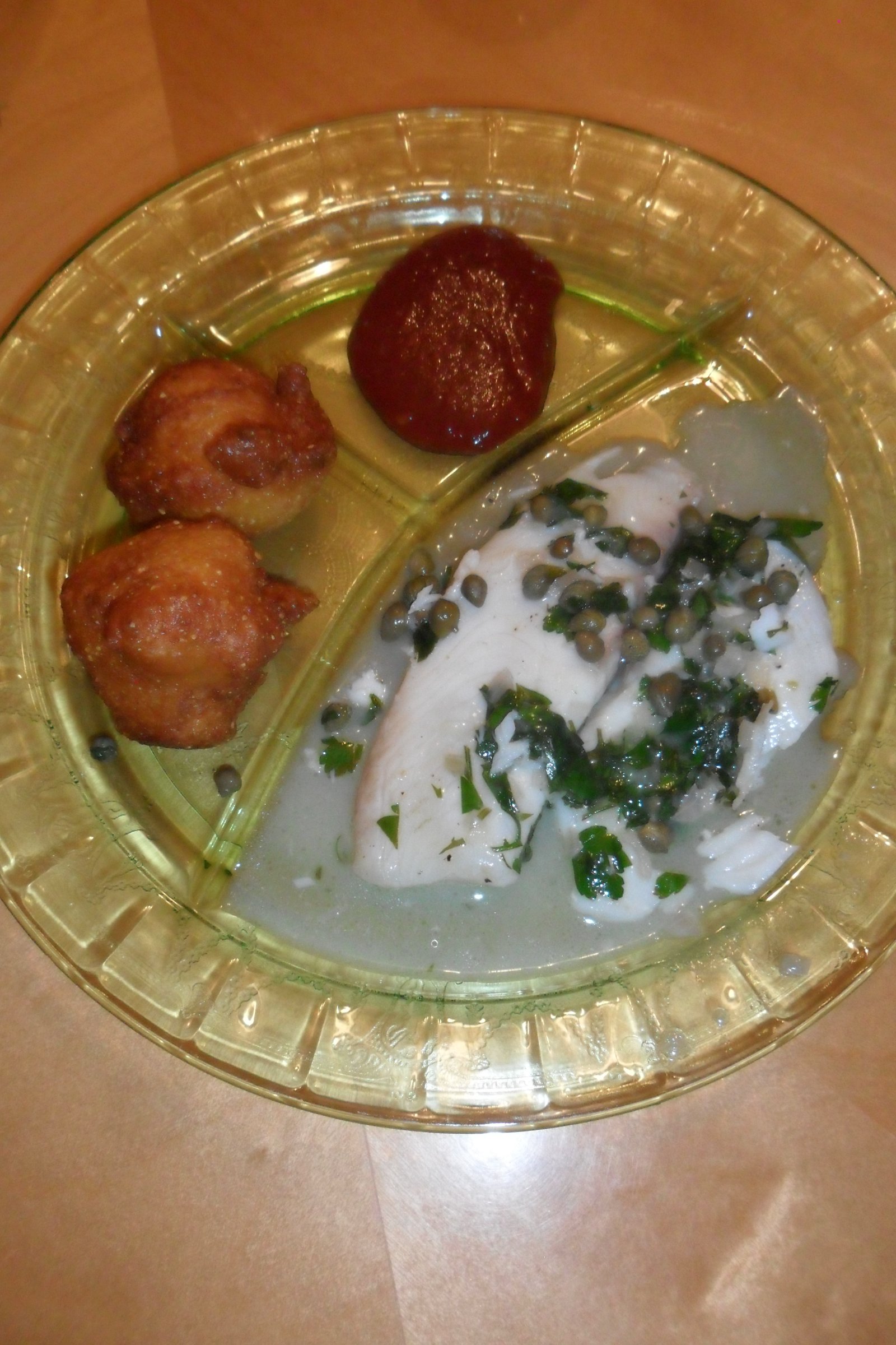 Hushpuppy appetizer and cocktail sauce with tilapia.