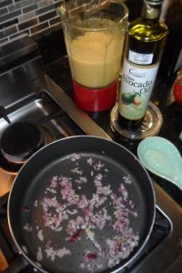 Starting onion with blended tomatoes in background.