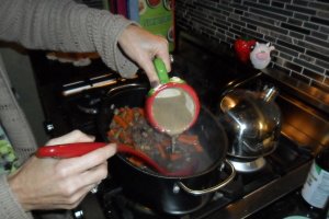 Thickening sauce with flour slurry.