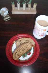 Pieces of kalacz on Christmas plate at work with coffee.