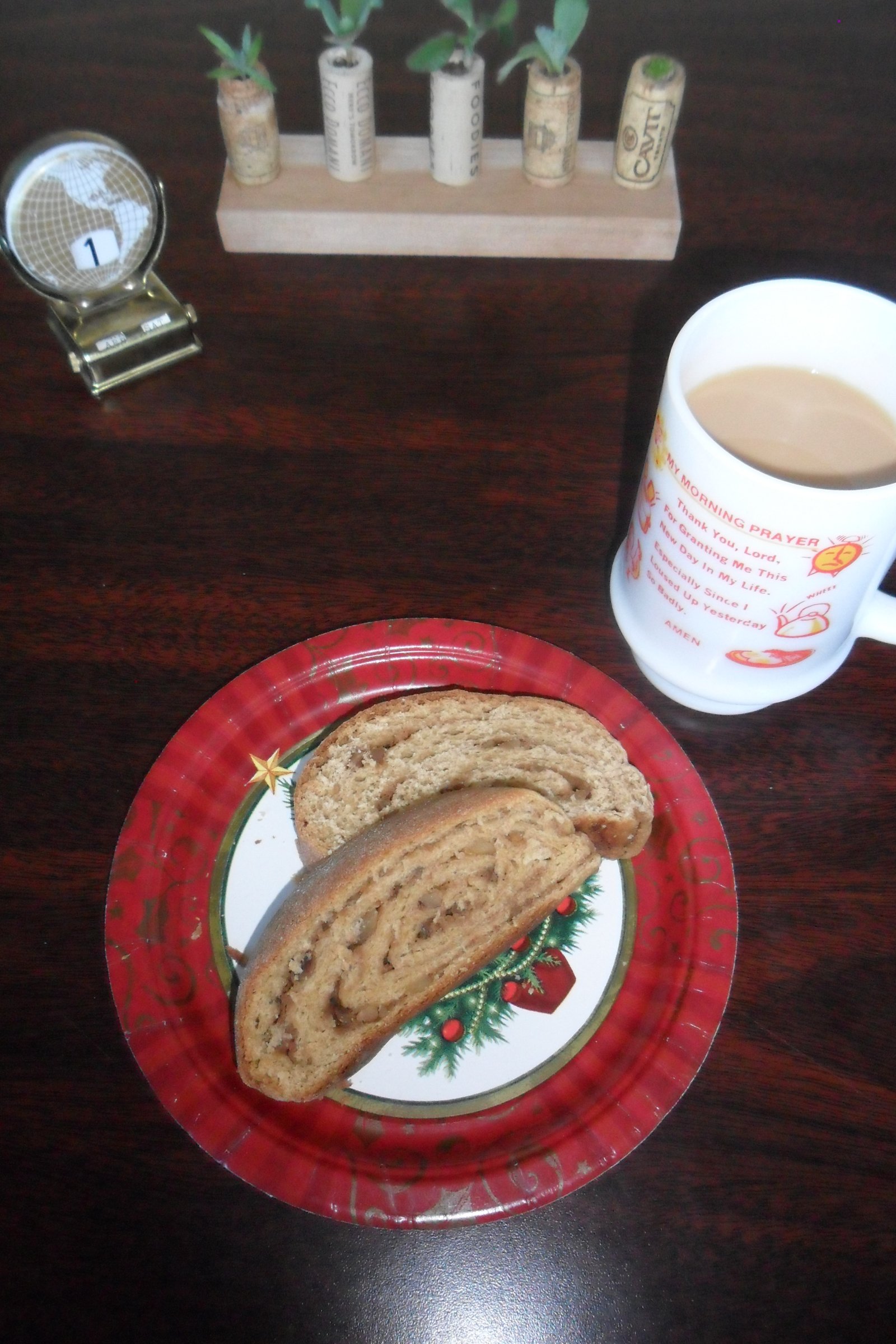 Pieces of kalacz on Christmas plate at work with coffee.