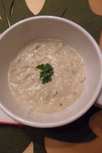 Bowl of cream of crab with parsley on leaf placemat