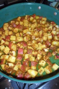 Potatoes mixed with cooked spices.