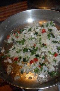 Onions and pepper in oily pan.