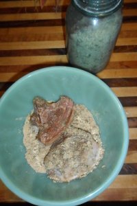 Pressing lamb into crumb mixture.