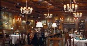 Tack Room with wood paneling and saddle decorations.