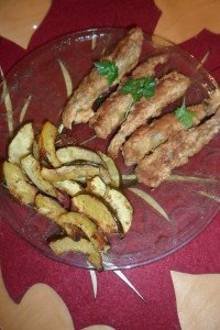 Smelt garnished with parsley served with roasted vegetables.