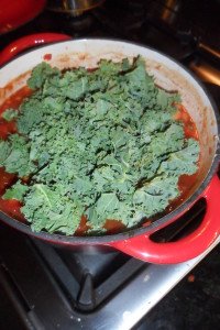 Adding kale to pot.