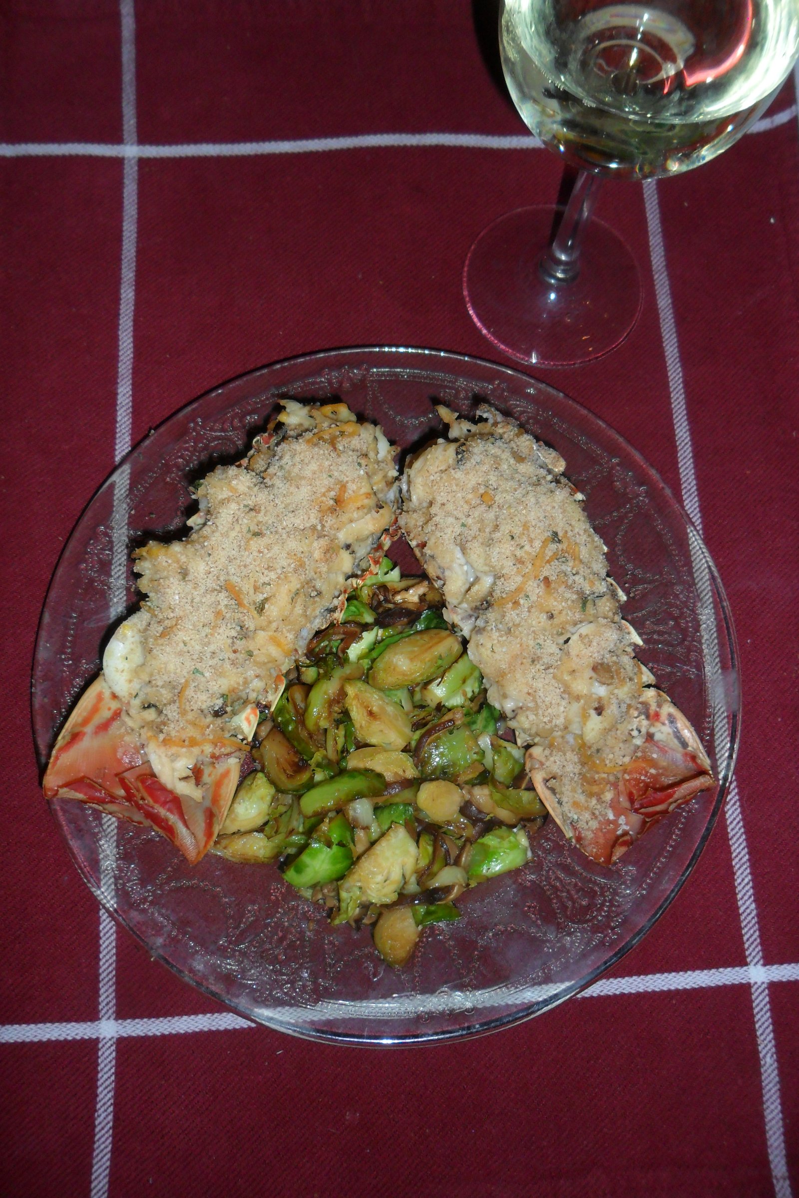 Serving two lobster tails around a pile of vegetables.