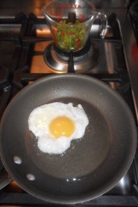 Greens on the side while frying egg.