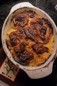 Baked potatoes au gratin in casserole dish.